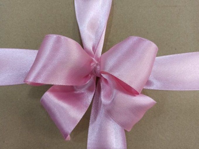 Ruban satin double face rose 40 mm noué en boucle
